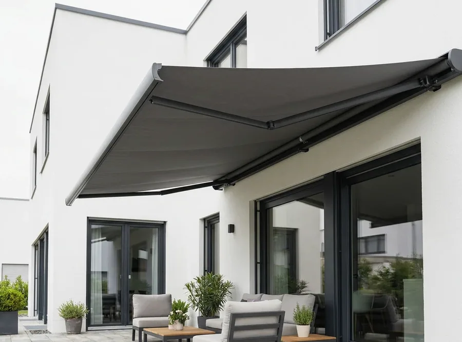 Solution-dyed acrylic awning canopy extended on folding arms, fabric colour even and unfaded in full sun